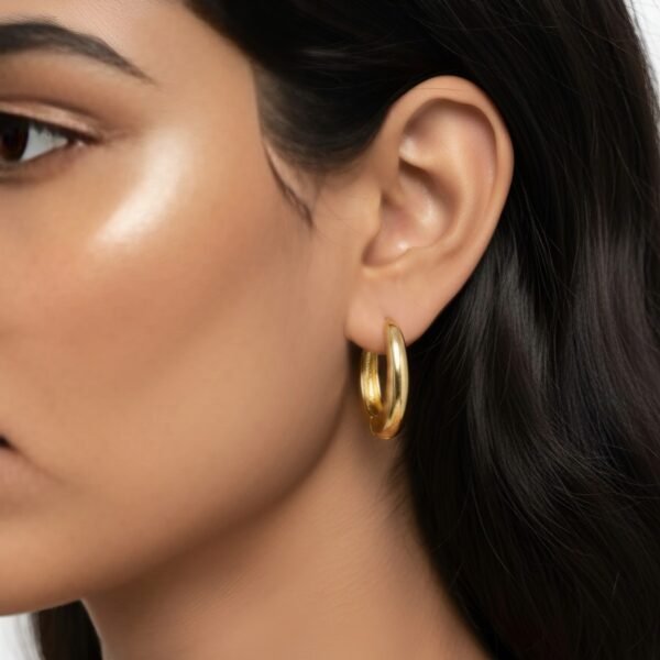 Side profile of a sleek, U-shaped gold plated minimalist hoop earring from DIVAART, highlighting its modern and elegant silhouette.