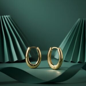 A pair of DIVAART's Gold Oval Hoop Earrings with a polished 18k gold plated finish, shown on a clean white background.